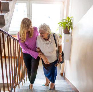 woman help the elderly woman