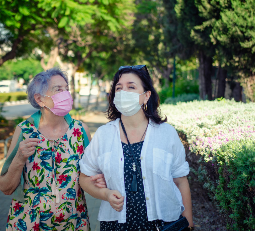 elderly woman and caretaker enjoy the view outdoor