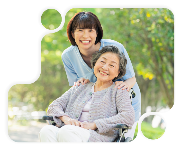 female caretaker and elderly woman smiling