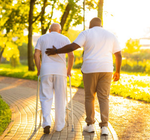 caretaker and elderly man take some walking outdoor