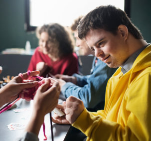 teenagers practice knitting