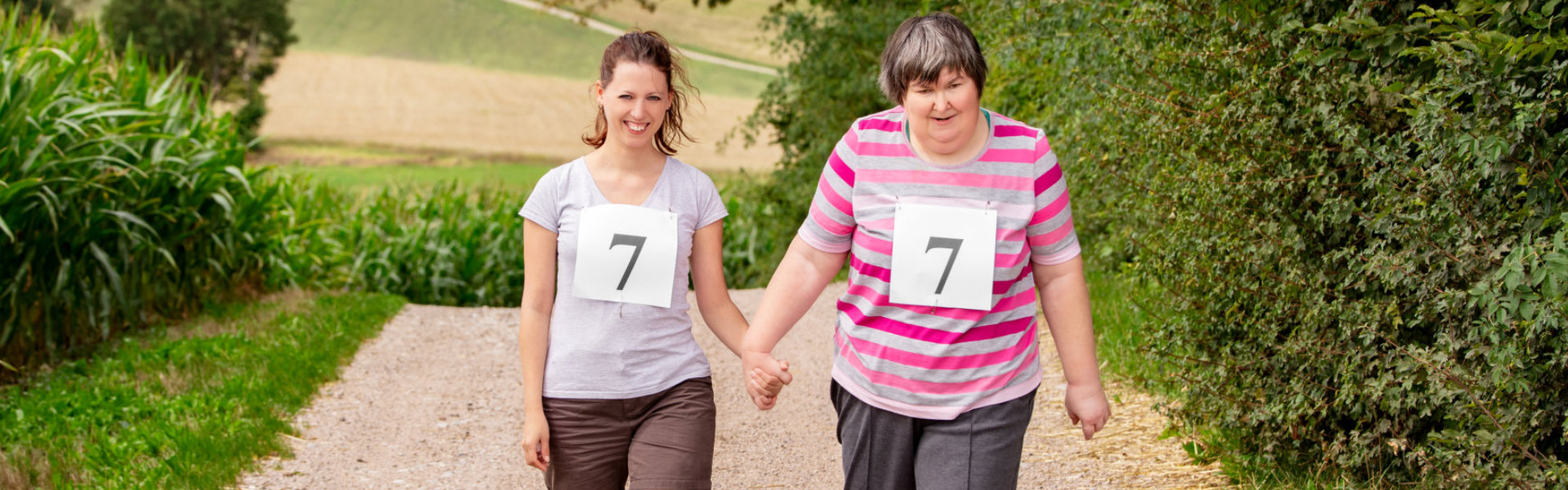 woman and a friend or therapist caregiver are walking hand in hand