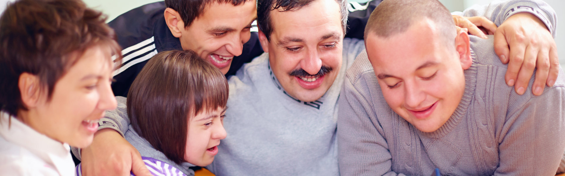group of happy people having fun with tablet